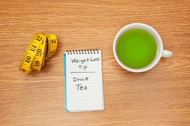 A note pad with the text weight loss tip - drink tea