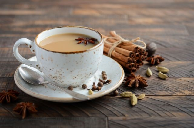 A cup of chai tea laying on a wooden surface. Is Chai Tea Good for Weight Loss?
