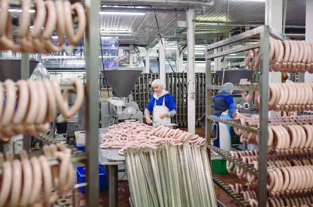 many different meats getting processed in a food factory