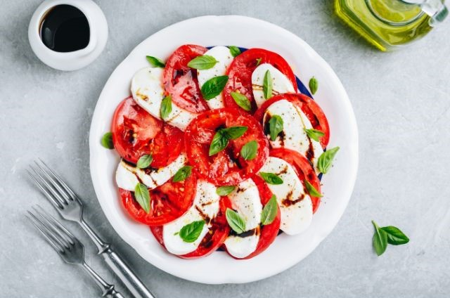 caprese salad served in a white plate