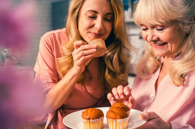 two women eating a muffin