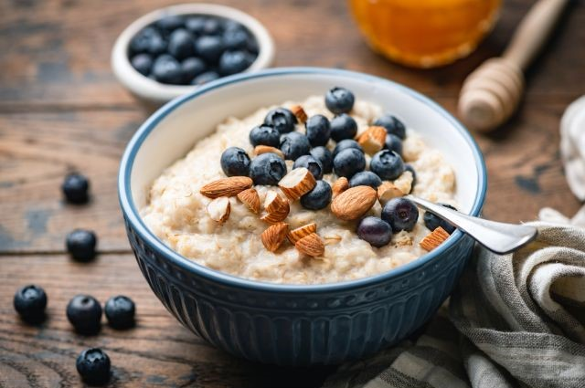 oatmeal mized with blueberries and almonds served in a bowl