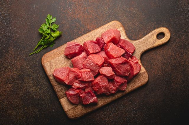 cut pieces of lean meat laying on a cutting board