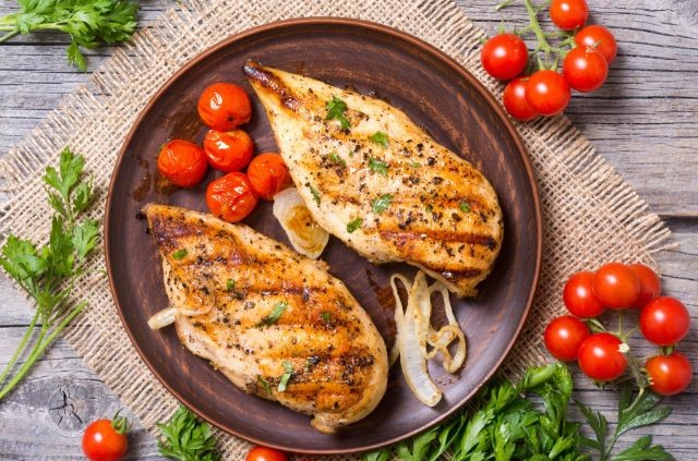 two pieces of chicken breast on a pan