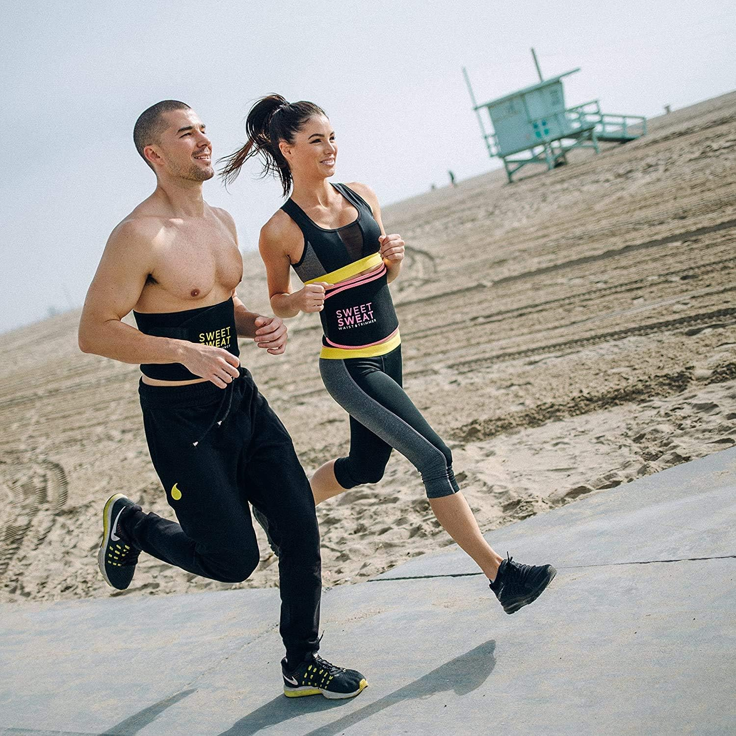 A man and a woman running wearing a waist trimmer