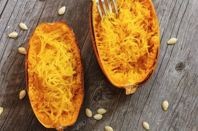 spaghetti squash laying on a wooden surface