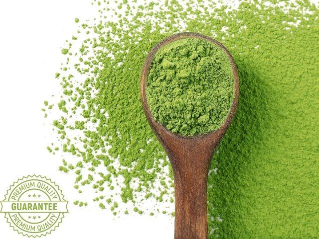 matcha powder on a small wooden spoon
