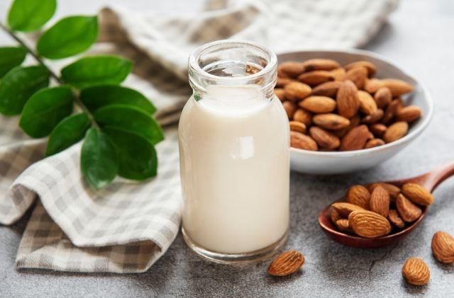 Almonds and milk are sitting on a table (Is Almond Milk Good for Weight Loss?)
