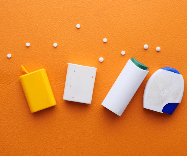 different type of artificial sweeteners laying on an orange background